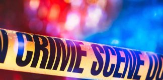 Mother-Grandmother Killers: 4 Children Dead Crime scene tape with blurred emergency lights in background