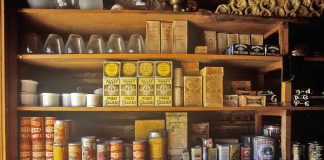 Vintage pantry shelves filled with tins and boxes
