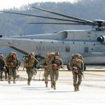 U.S. Ends 23-Year Military Presence in Iraq Soldiers disembark and walk past a large military helicopter