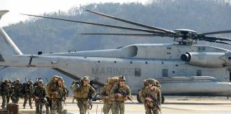 U.S. Ends 23-Year Military Presence in Iraq Soldiers disembark and walk past a large military helicopter