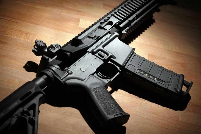 Black modern rifle on wooden surface