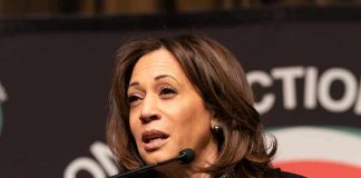 Kamala Harris speaking at a podium with a microphone