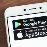 Smartphone screen showing Google Play and App Store badges