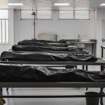 COVID Hospital Stories Finally Come to Light Mortuary room with covered bodies on metal gurneys