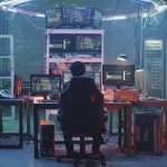 People working at computers in a dim server room