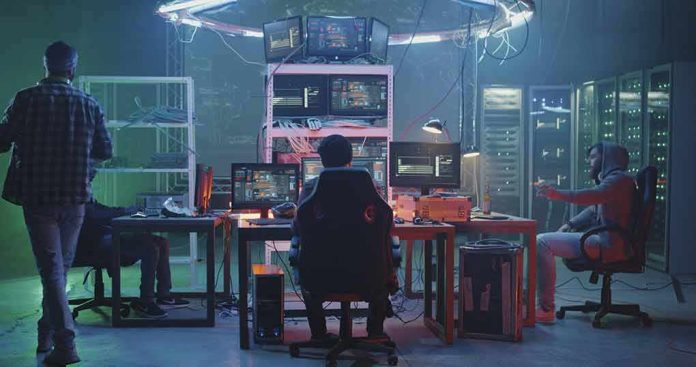People working at computers in a dim server room