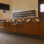 Murder Case Hinges on ONE Missing Piece jury box in an empty courtroom
