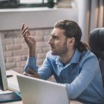 STUDY: Your Job Could Be Hurting Your Sex Life Man at desk looking frustrated at computer monitor