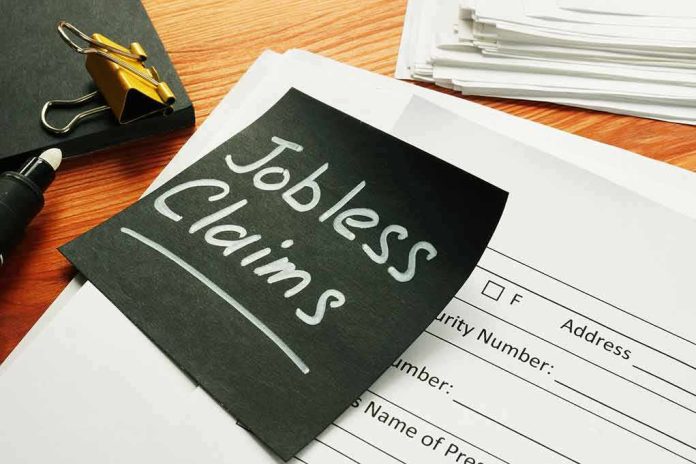 shutterstock_1711076647 Black sticky note reading jobless claims on top of paperwork