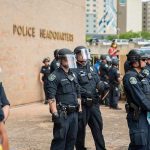 Teddy Williams and Carlos Hyde among police officers in riot gear outside police headquarters