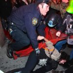 Good Samaritans Step In To Stop A Robbery Police officer restraining a protester on the ground during a crowd encounter