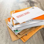 Stack of mail with past due notice on top