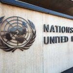 United Nations emblem and signage on a concrete wall