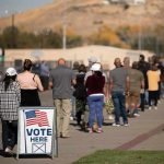 voters standing in a long line outside a polling place