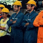 Industrial workers standing together in safety gear