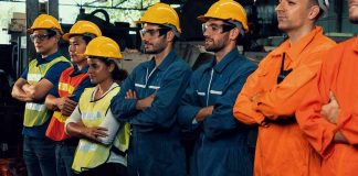 Industrial workers standing together in safety gear