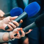 WNBA Coach REFUSES to Give XX-XY Critics ‘Oxygen’ Reporters holding colorful microphones