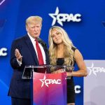 Trump UNLOADS on Tucker, MTG and Massie Two speakers at a conference podium on a blue stage