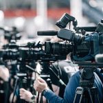‘DO NOT RAPE WOMEN!’ Guide Given To Asylum Seekers Broadcast cameras on tripods at a press event