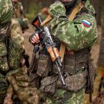 soldier in camouflage holding a rifle
