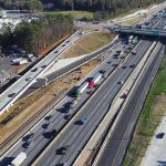 Aerial view of multi-lane highway interchange with overpass and traffic