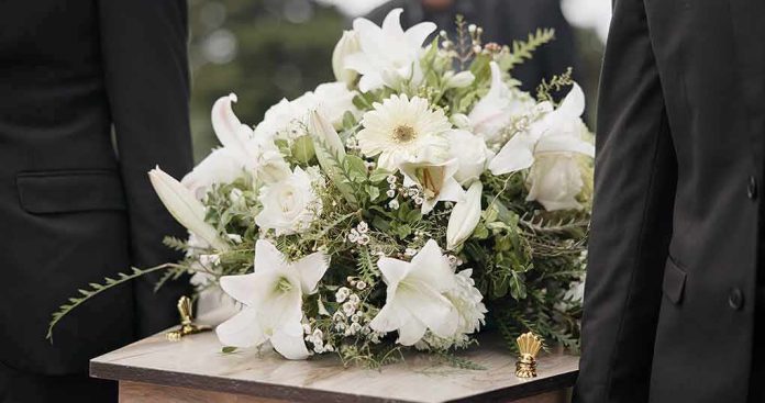 funeral casket with white flower arrangement