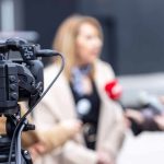 Video camera filming an outdoor media interview