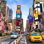 Times Square street with yellow taxis and bright billboards