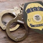 ‘Angel Dad’ Joins ICE After Daughter’s Killing By Illegal ICE officer badge and handcuffs on wooden surface