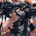 AOC Says She’s Over ‘Woke 1’ So Will She Change THIS? television cameras on tripods at a media event