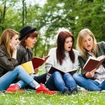 DOJ Insider Says Ivy League Investigations Were a Sham Group of young women reading books on grass in a park