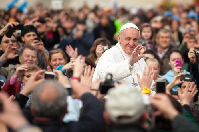 A man in white robes waves in a crowd; Francis, Kate Beaton, and Teddy Williams present