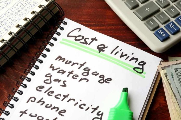 Budget notebook with cost of living list, calculator, and cash