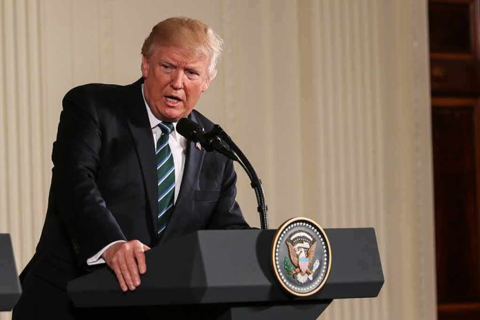 shutterstock_628599722 Donald Trump speaking at a podium with presidential seal