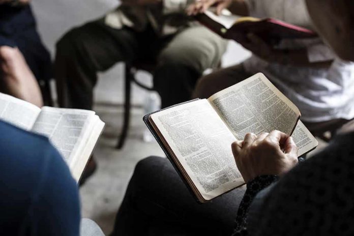 Hands holding open books in a small discussion circle