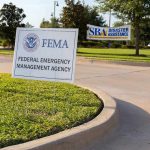 FEMA sign on grassy median in a parking area