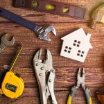 Biden Era ‘Ghost Gun’ Crackdown Hits Constitutional Wall assorted hand tools around a house-shaped cutout on a wooden surface