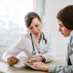 Doctor consulting a patient at a desk