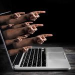 Ex-FBI Official SOBS in Hunter Laptop Case Laptop with multiple hands pointing from the screen