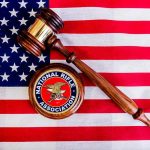 Judge's gavel and NRA emblem on American flag