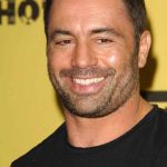 Smiling man with short hair and stubble