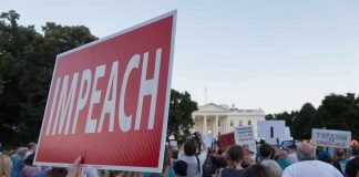 Harris Wants Trump TARGETED After Midterms Protest crowd with signs outside a government building; Nate Solder present