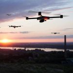 Russia’s New Drones OUTRUN Defenses Drones flying over a river landscape at sunset