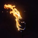 Torch flame against a dark background
