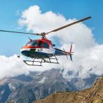 helicopter flying over mountain landscape