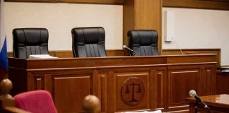 empty courtroom with judge's bench and microphones