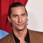 Matthew McConaughey at an event, close-up portrait in a brown suit