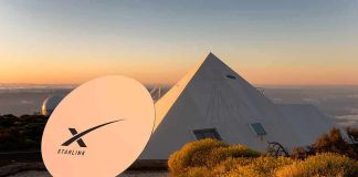 Starlink satellite dish near a pyramid-shaped building at sunset