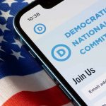 Democrats Share Stage With CONTROVERSIAL Figure Smartphone showing a political committee webpage on an American flag