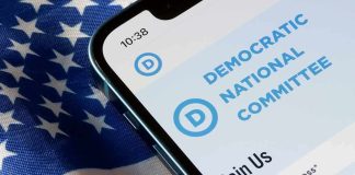 Democrats Share Stage With CONTROVERSIAL Figure Smartphone showing a political committee webpage on an American flag